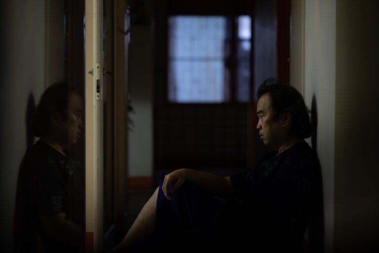 Asian man sitting alone with a depressed and lonely attitude