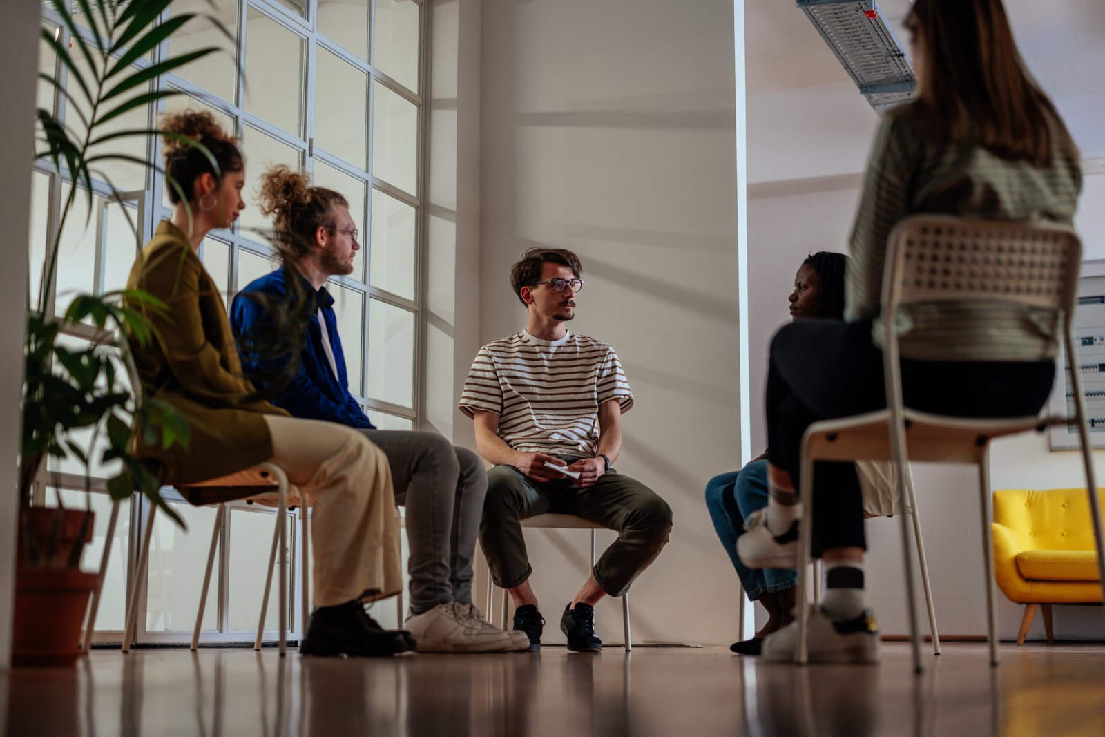 Friendly diverse people taking part in group therapy session
