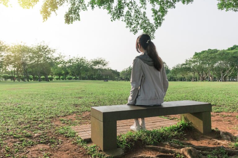 woman sitting on a bench in the park