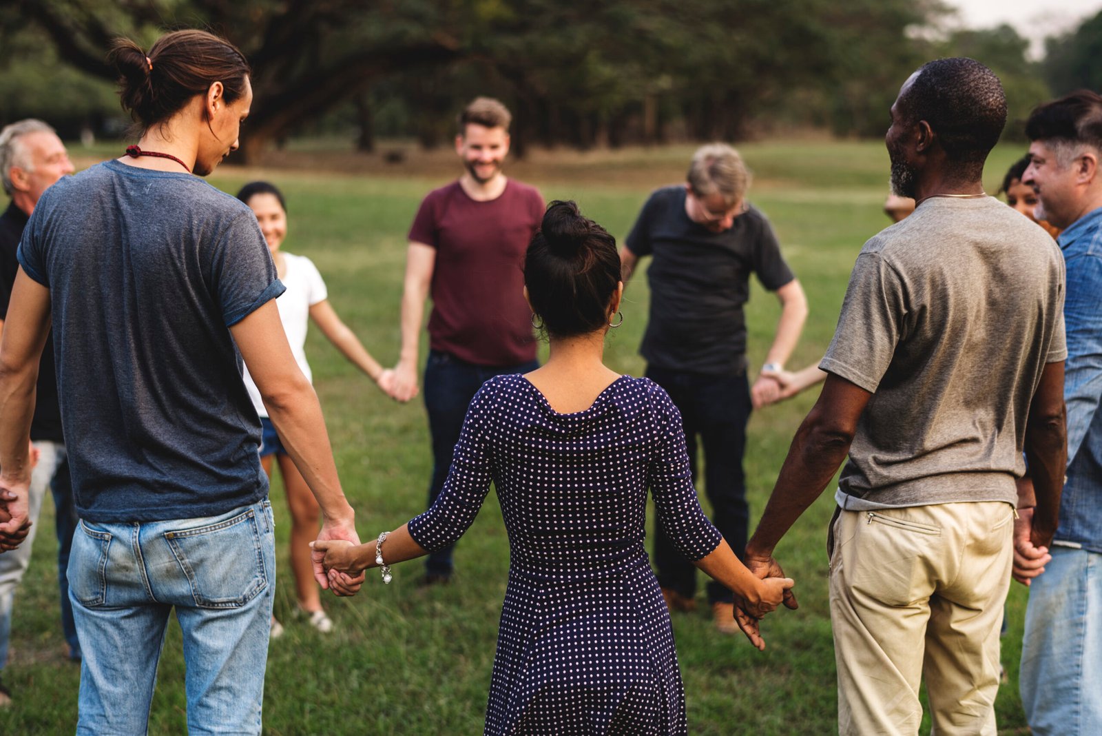 Group of people holding hand together in the park