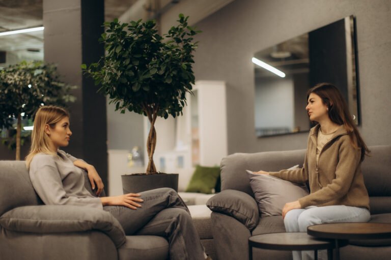 Two Women Having a Conversation in a Cozy Indoor Setting