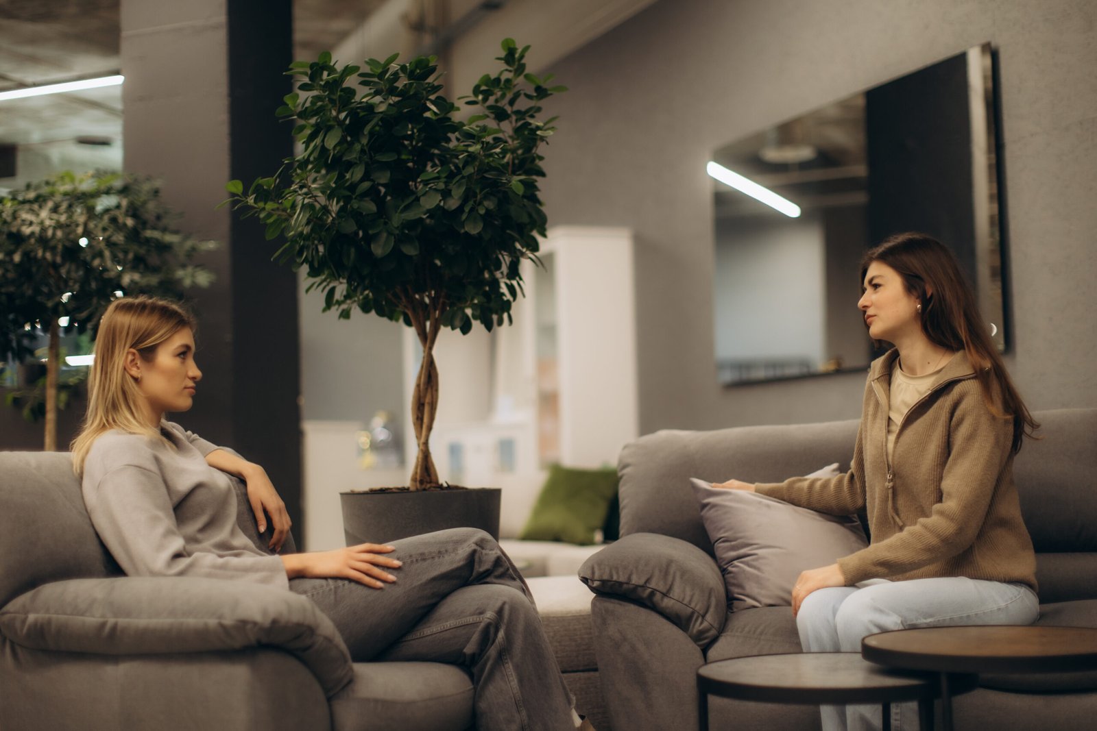 Two Women Having a Conversation in a Cozy Indoor Setting