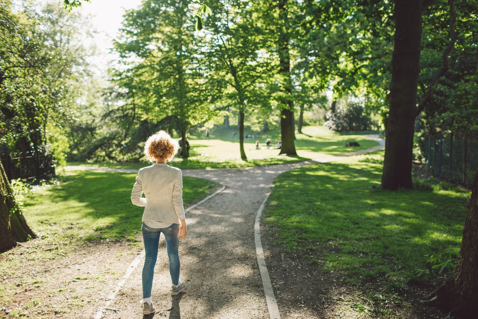 Full Length Of Woman Walking On Pathway At Park