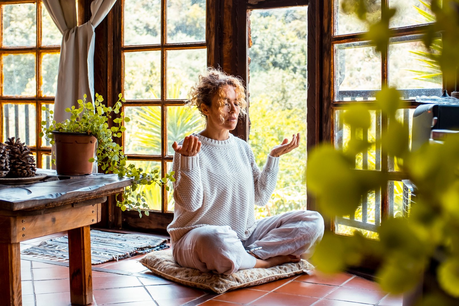 One woman at home indoor doing yoga asana meditation exercise for mental and body health. Healthy and natural lifestyle female people sitting on the floor. Meditation and zenlike activity alone
