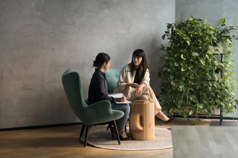Busy diverse business women talking in office lounge zone