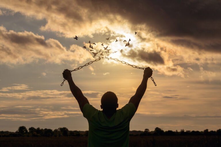 Man raised his hands and broke the chains that turned into birds.