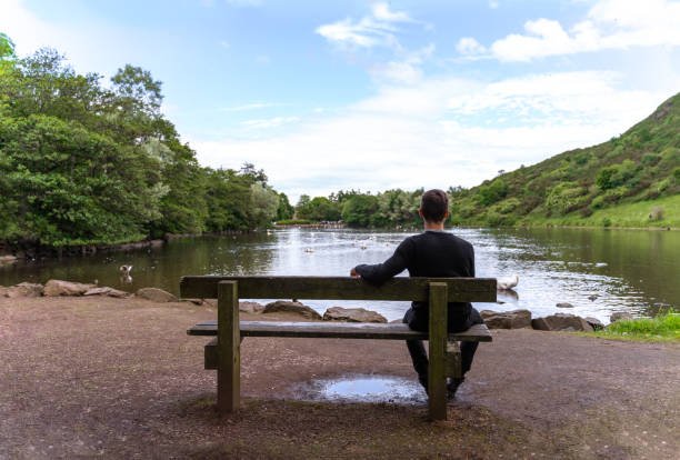 feeling depressed and lonely. Seated alone on a bench