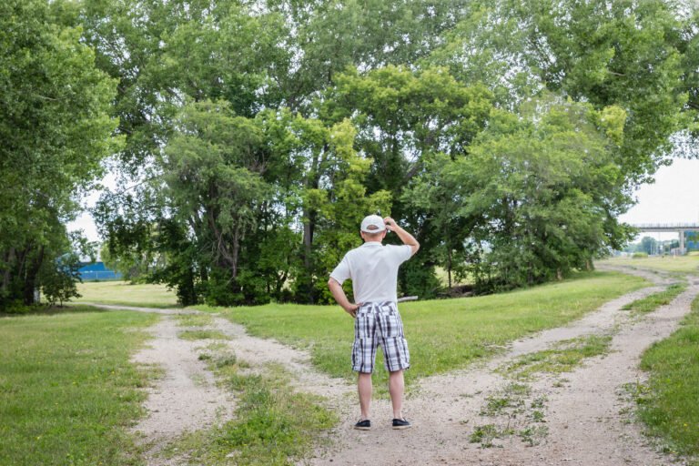 man standing at a crossroads wondering which way to go