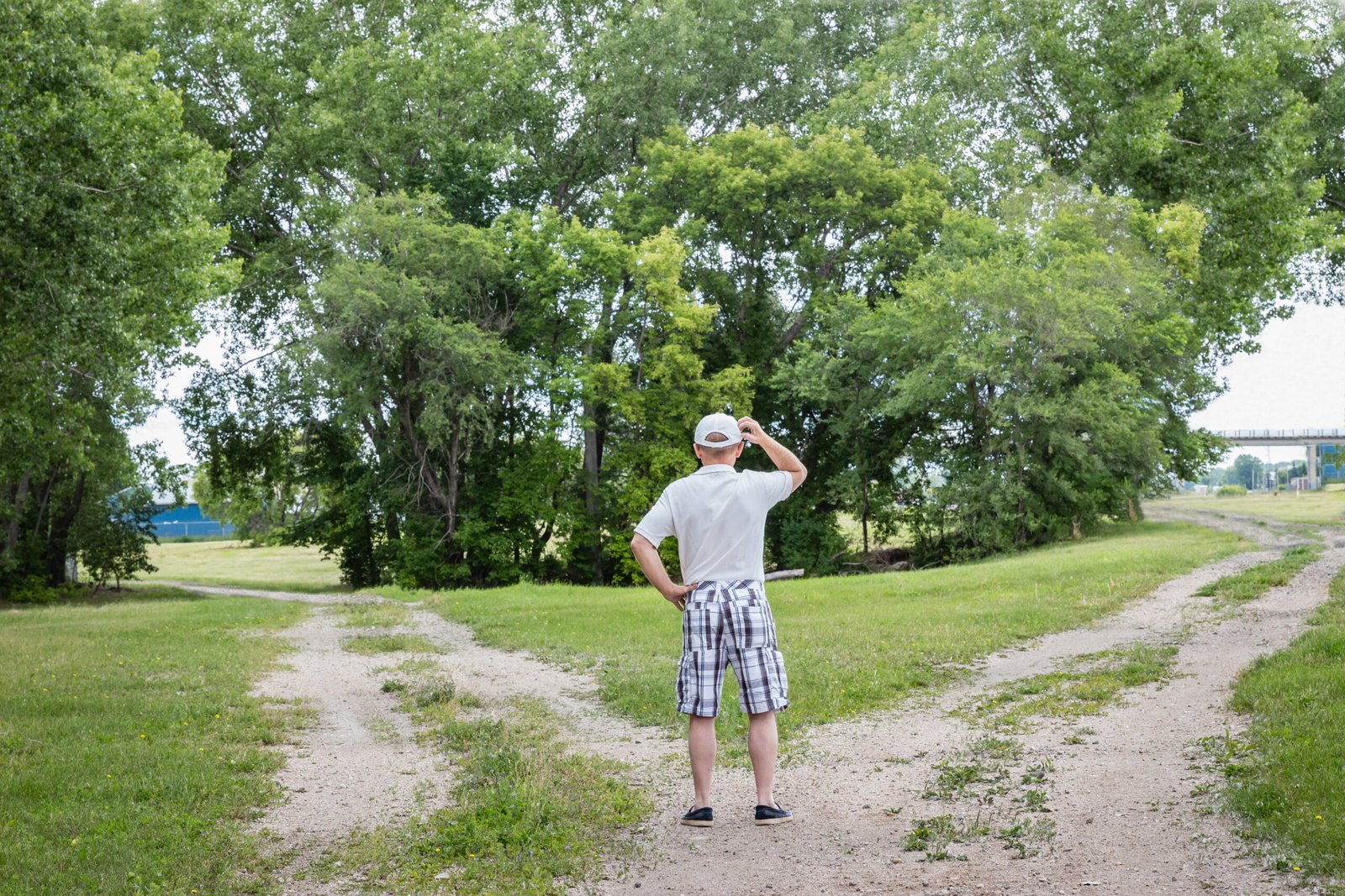 man standing at a crossroads wondering which way to go