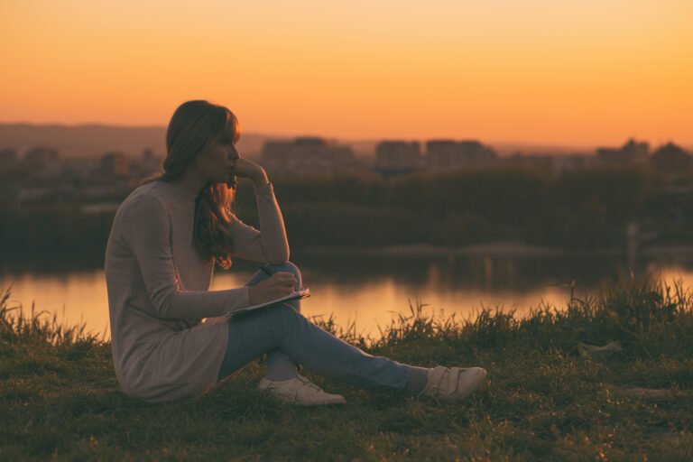 Sad woman thinking and writing