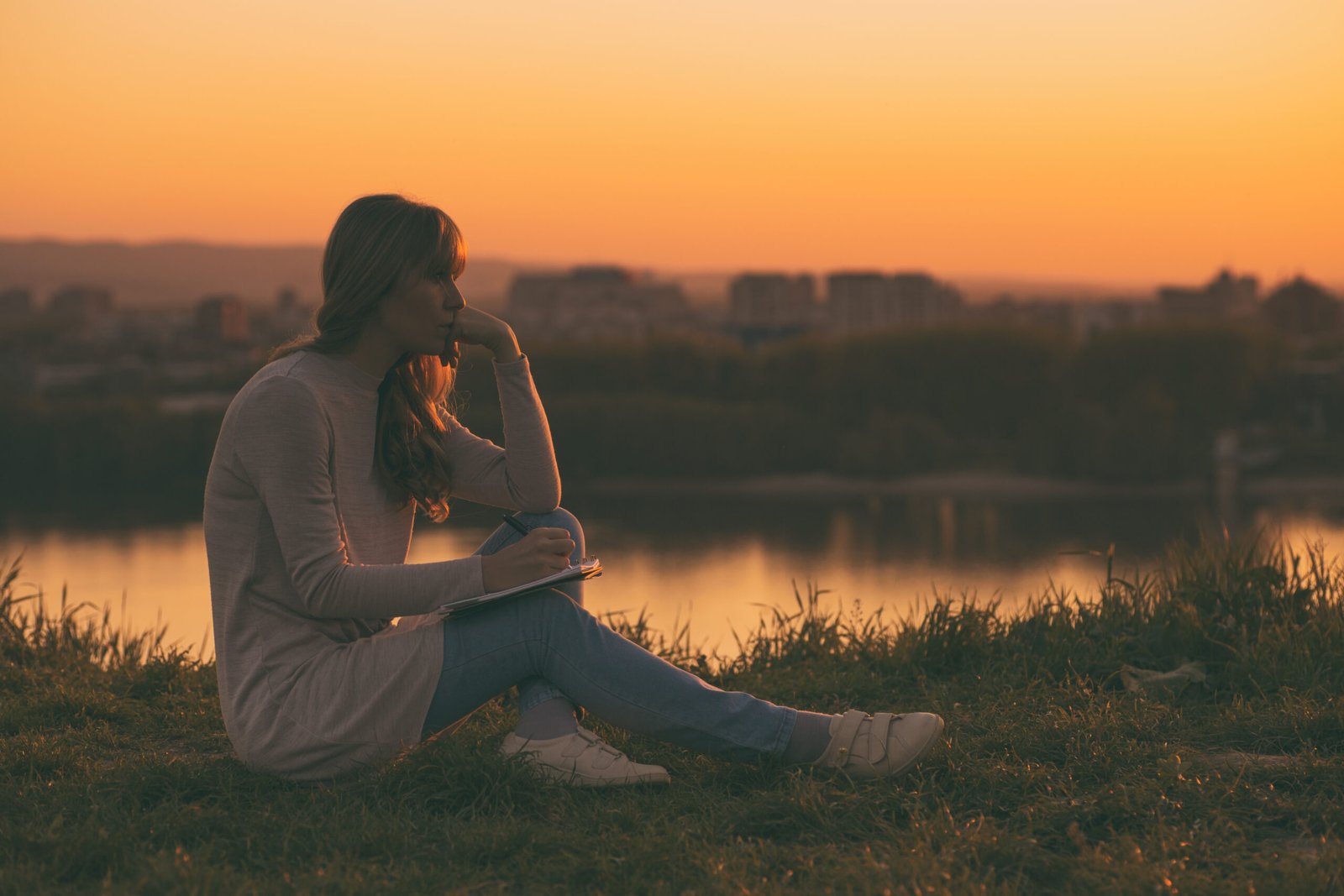 Sad woman thinking and writing