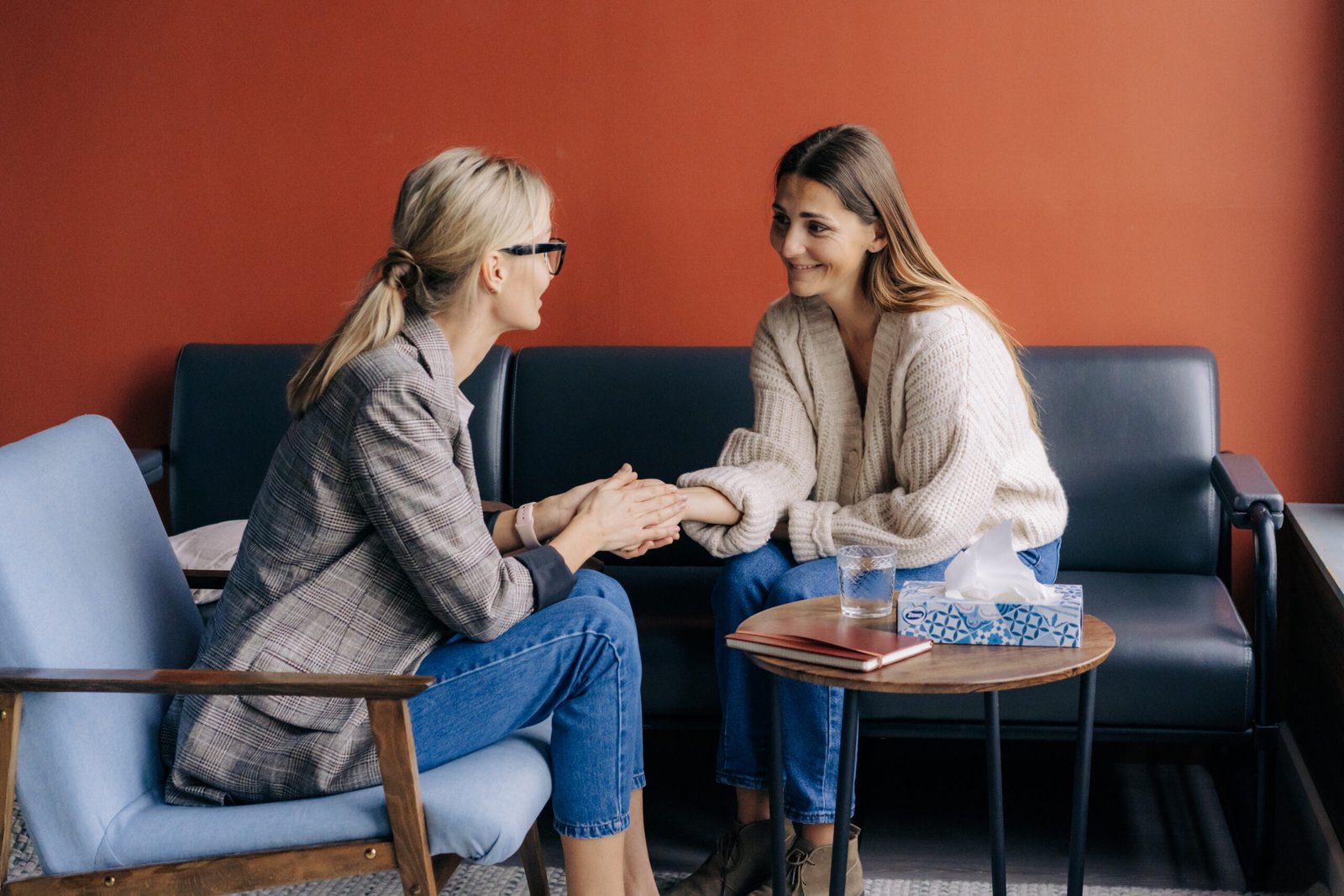 Empathic Female Psychologist Holding Female Client's Hand Giving Mental Professional Support