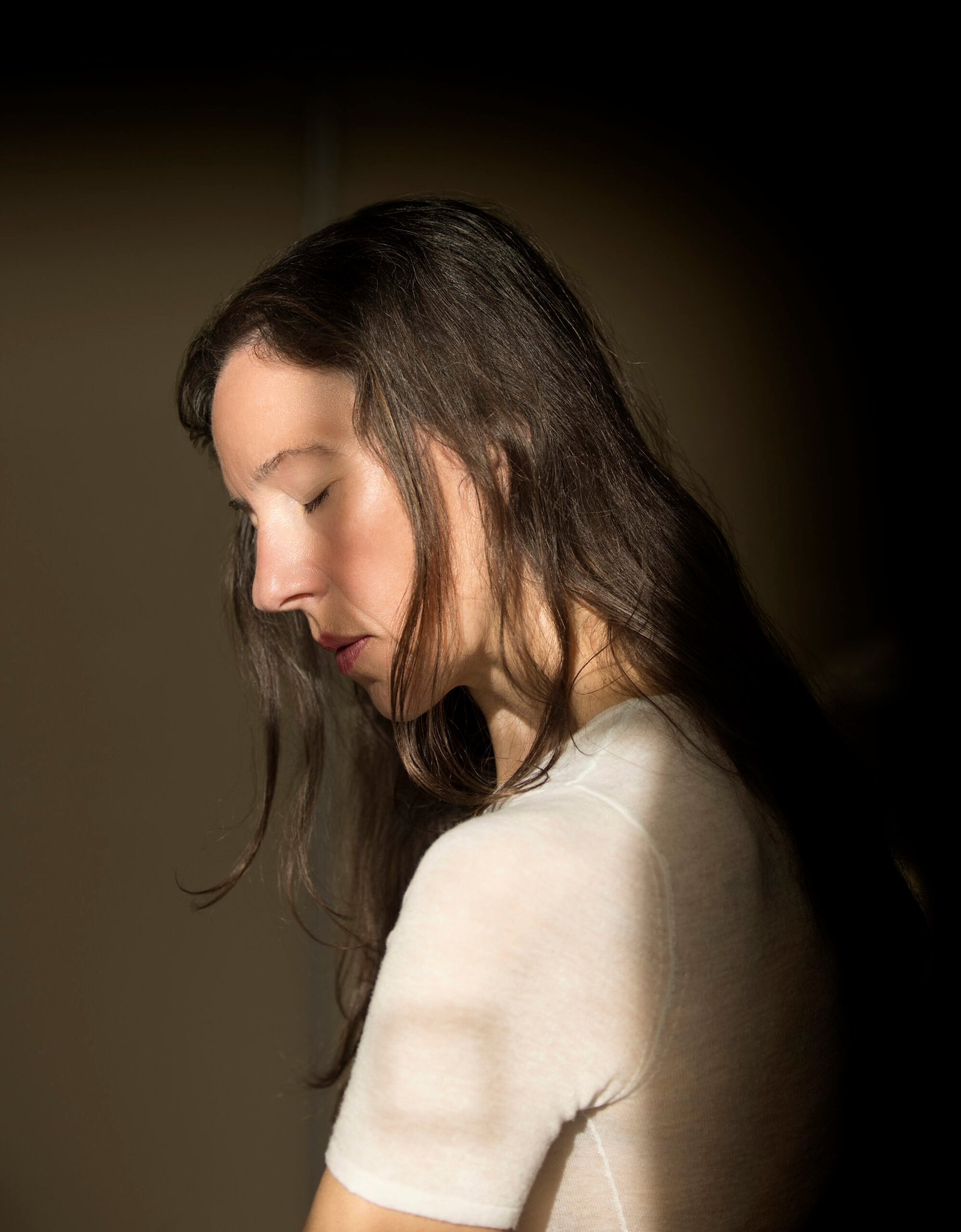 Woman Sitting On A Chair With White Wool Sweater In Thoughtful Attitude V