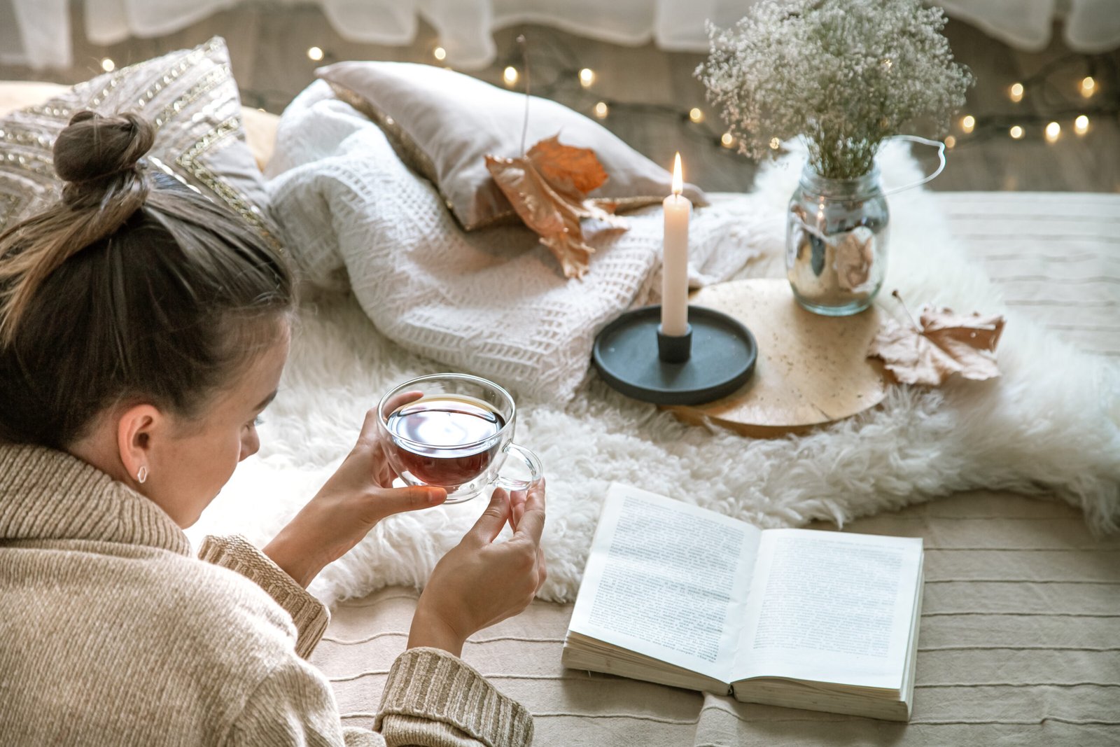 Cozy autumn or winter at home, a woman in a knitted sweater