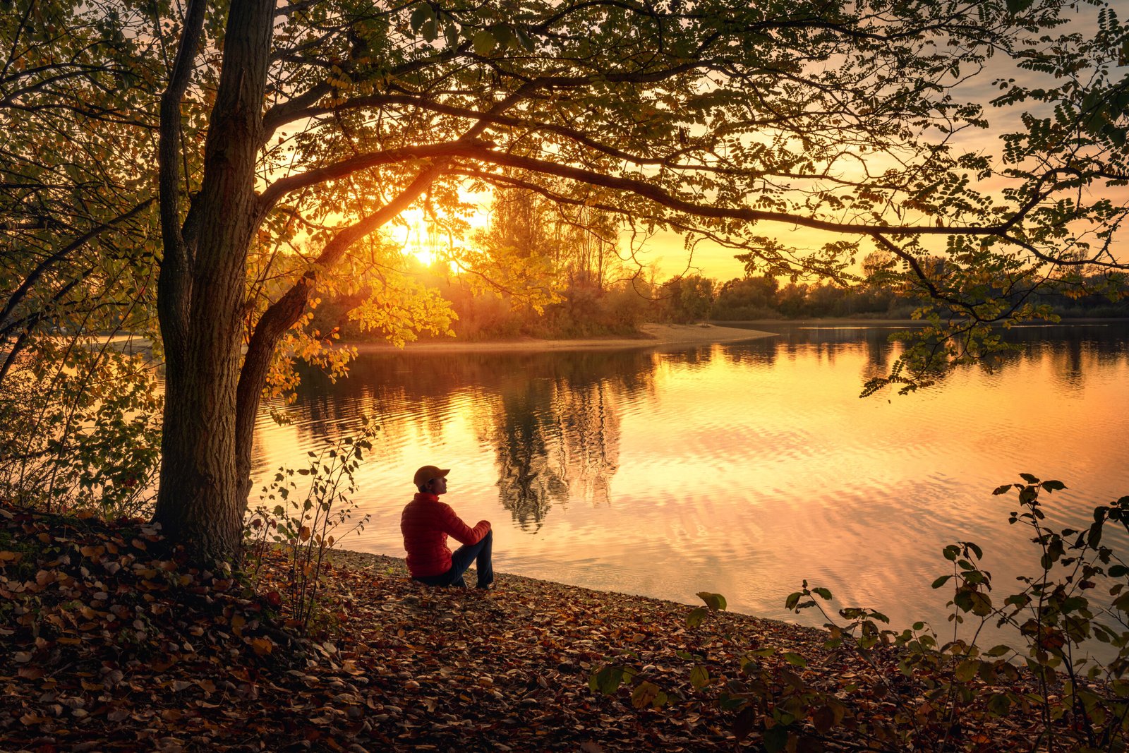 Man enjoying amazing sunset at a lake