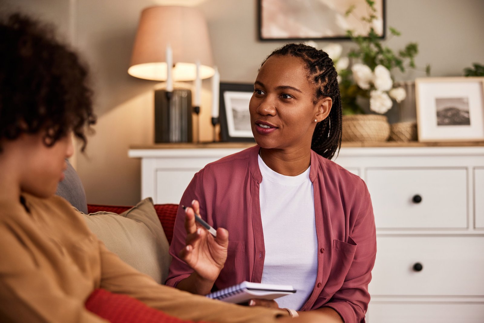 A beautiful African-American psychologist talking with a teenage boy.