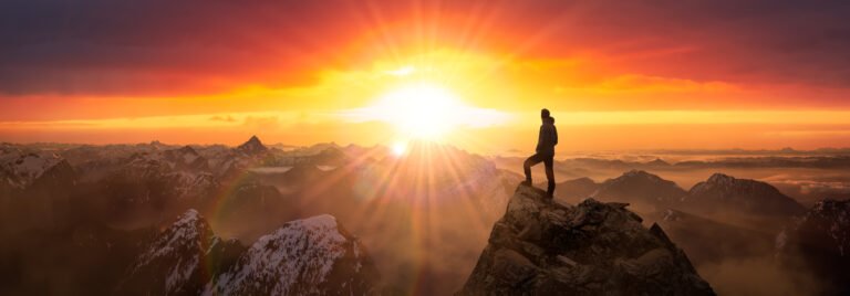 Magical Fantasy Adventure Composite of Man Hiking on top of a rocky mountain
