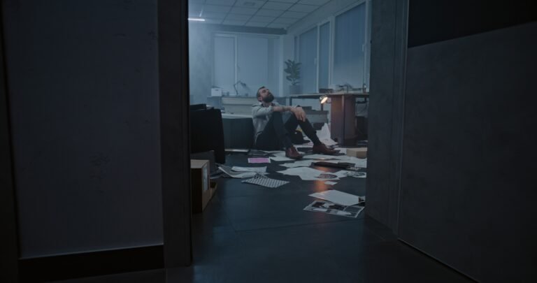 Depressed businessman in destroyed office room after financial crisis