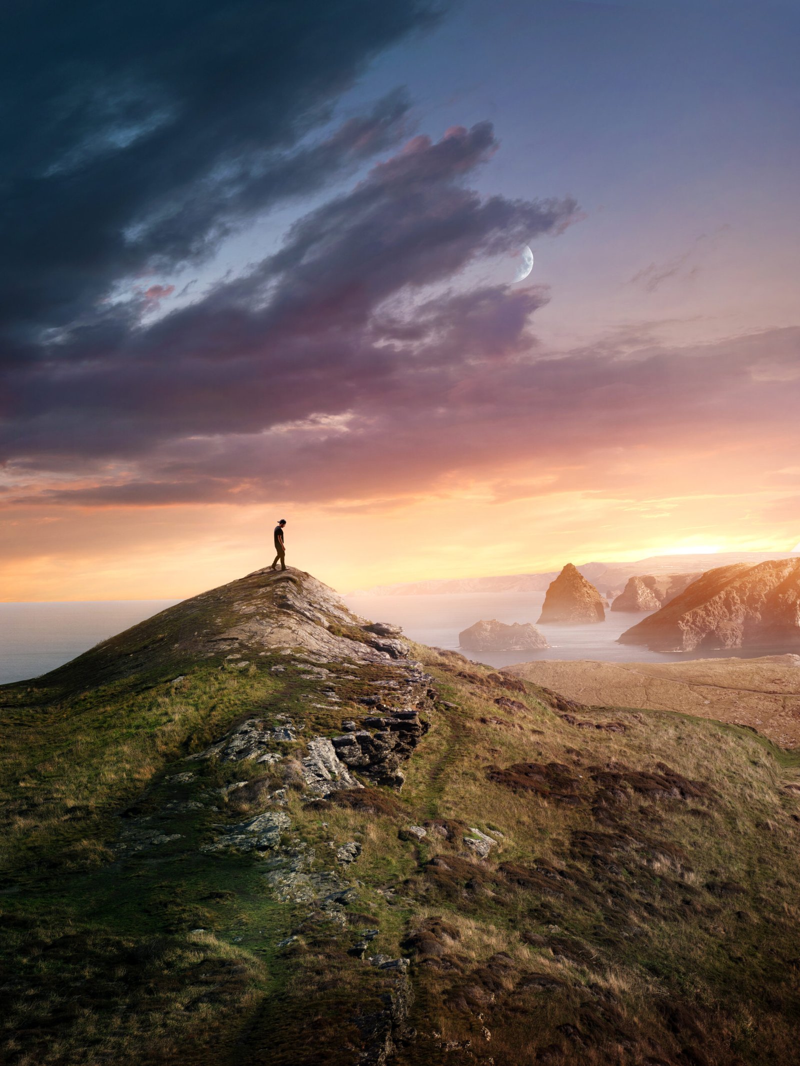 A Hiking Man Reaching A summit At Sunset