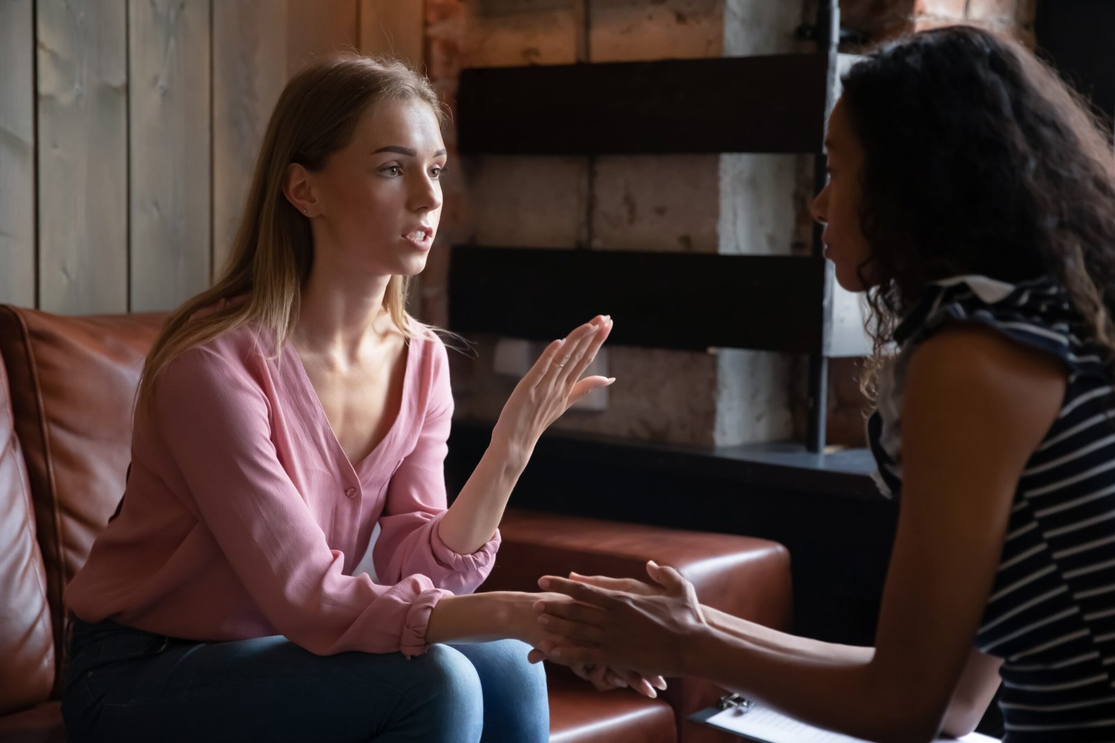 Young female mixed race best friends supporting each other.