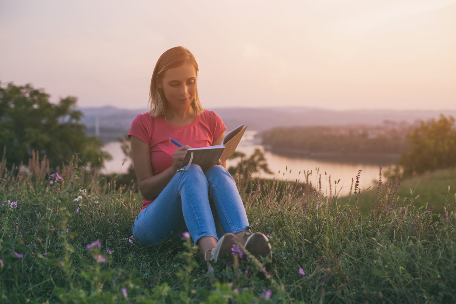Woman writing at the sunset