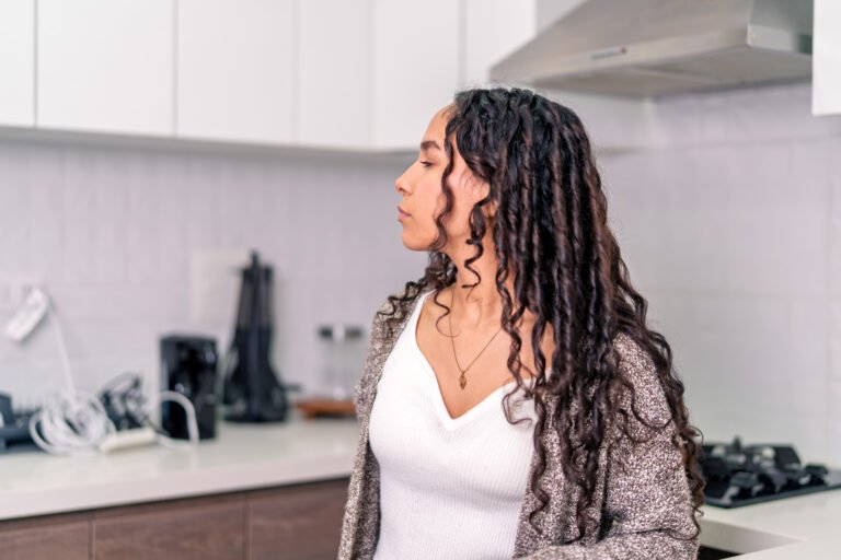 Young digital nomad working remotely from airbnb kitchen