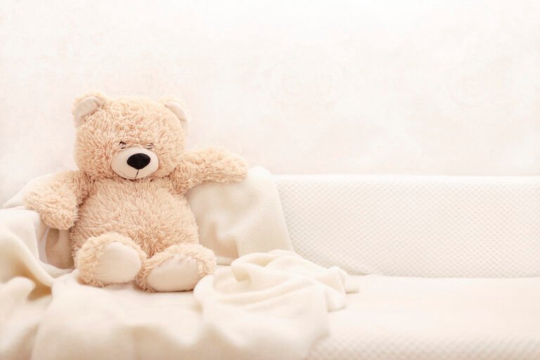 Children's toys - bears of brown and beige color are sitting on the sofa.