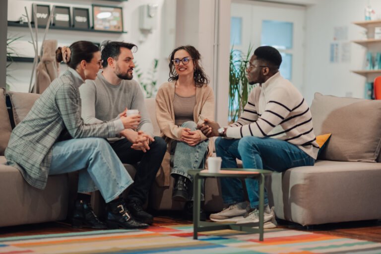 Coworkers having informal meeting in modern office