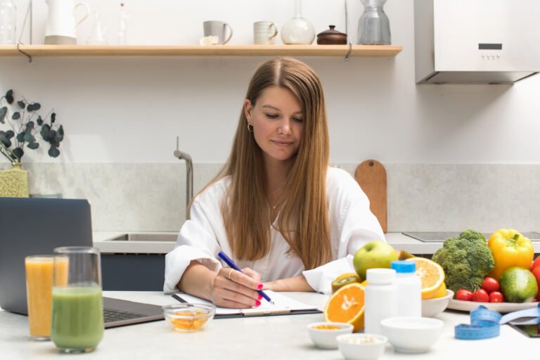 A nutritionist writes an appointment for vitamins and supplements and draws up a nutrition plan