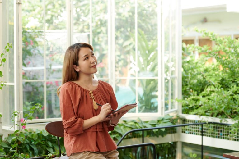 Pensive Woman Writing Down Ideas