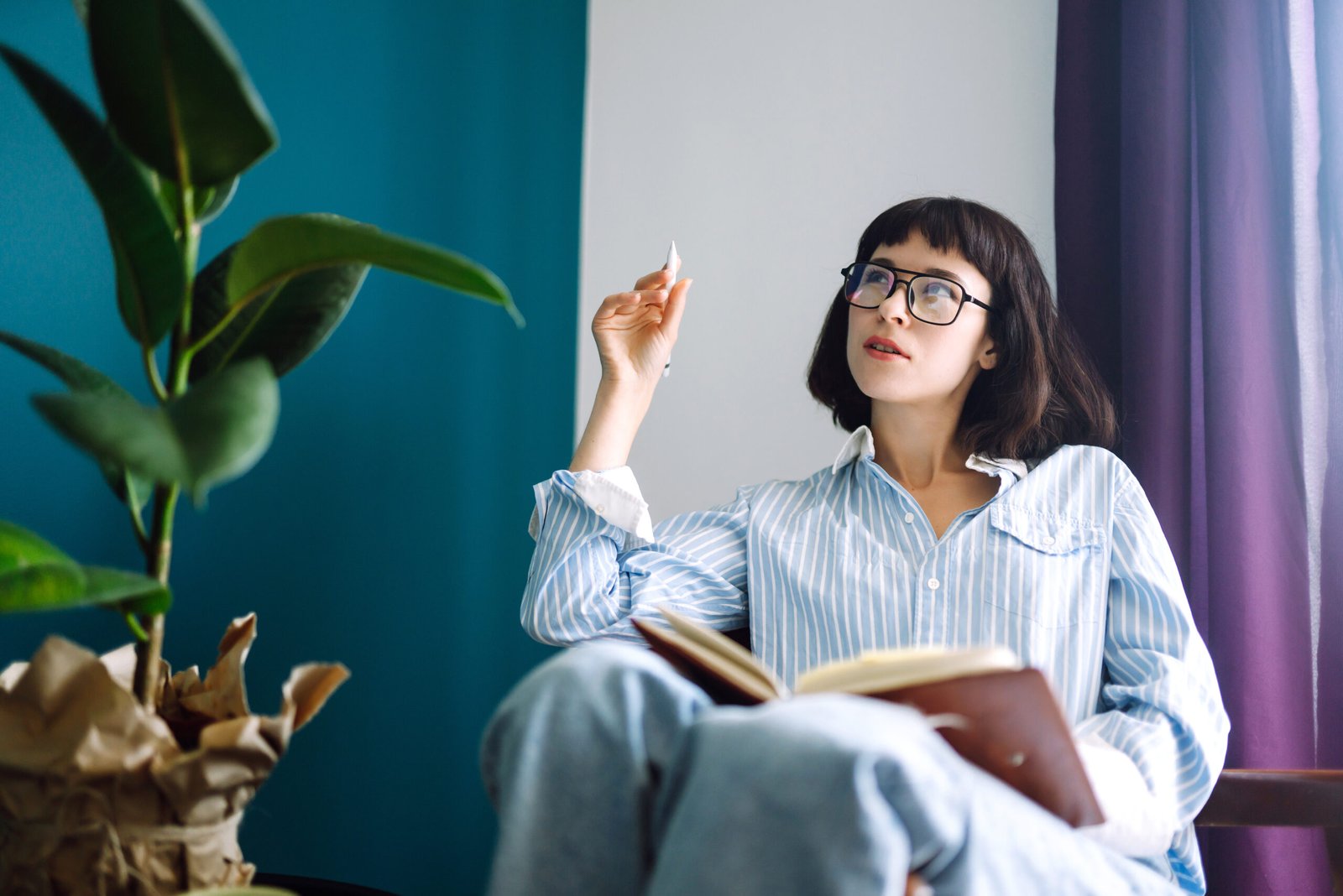 Beautiful woman at home writing and working with diary.
