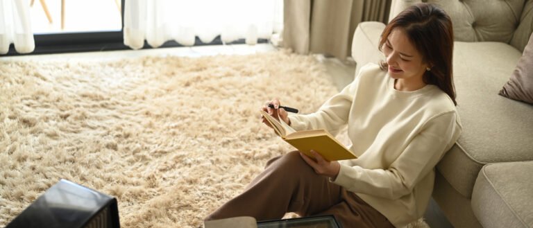 Pleasant woman making notes, agenda plan planning daily appointment on notebook. Leisure activity, positive mood concept.