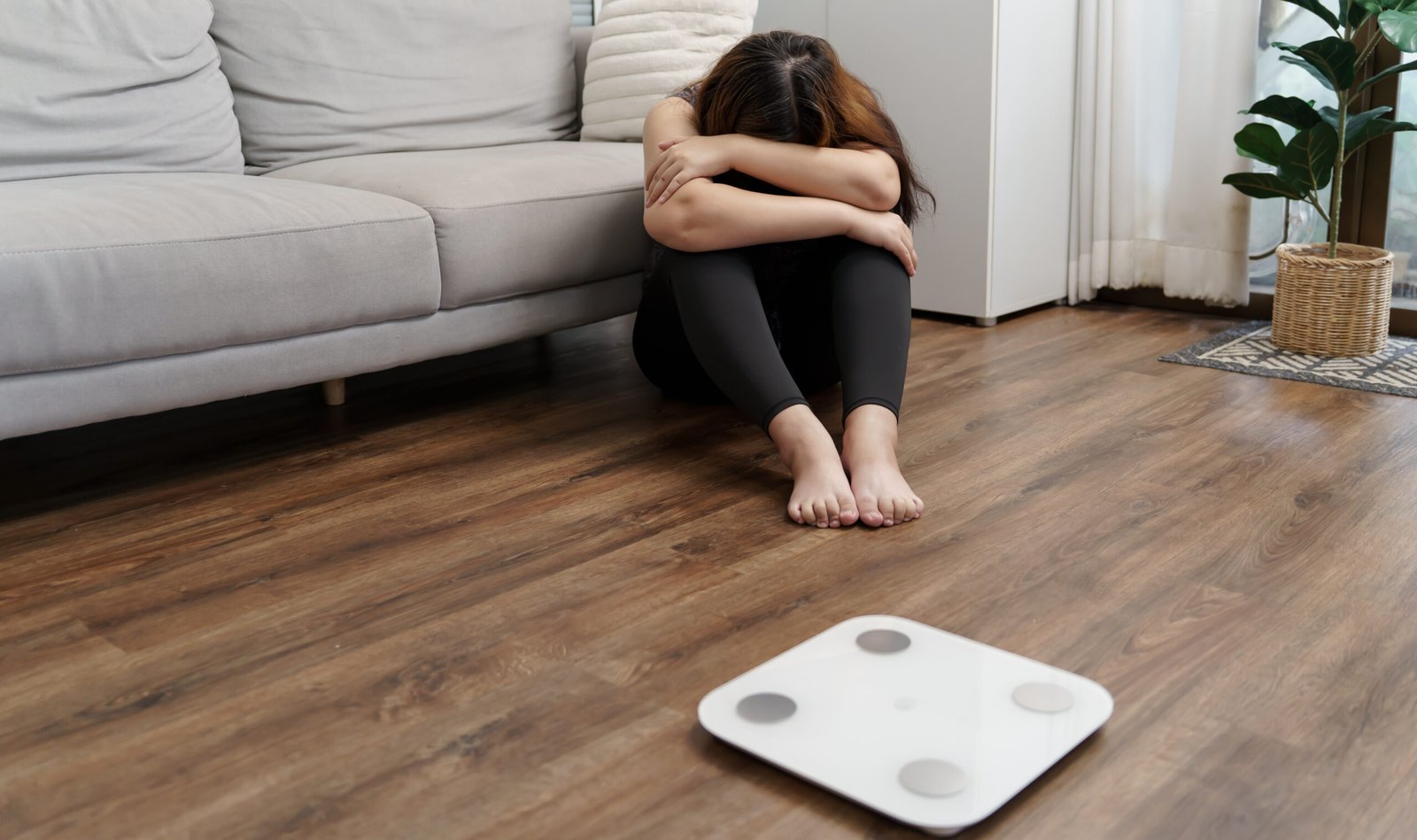 Sad woman with fat upset bored of dieting Weight loss fail Fat diet and scale sad asian woman on weight scale at home weight control