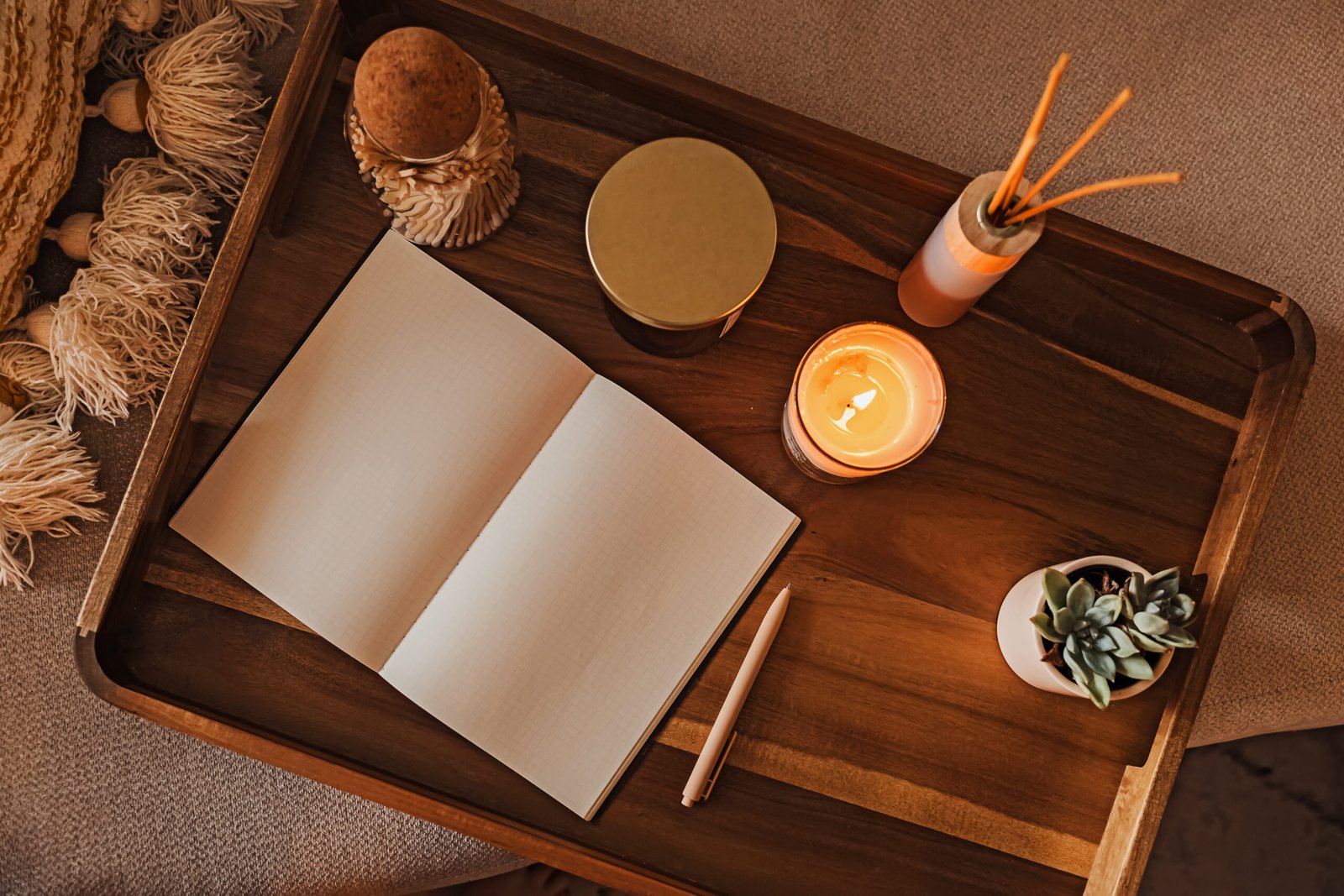 Cozy Workspace with Open Notebook and Candle