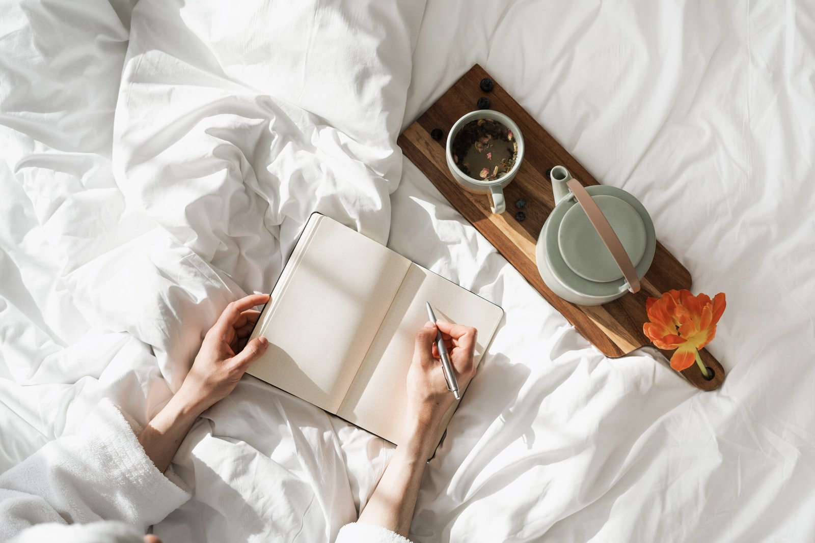 Person making notes when sitting in bed