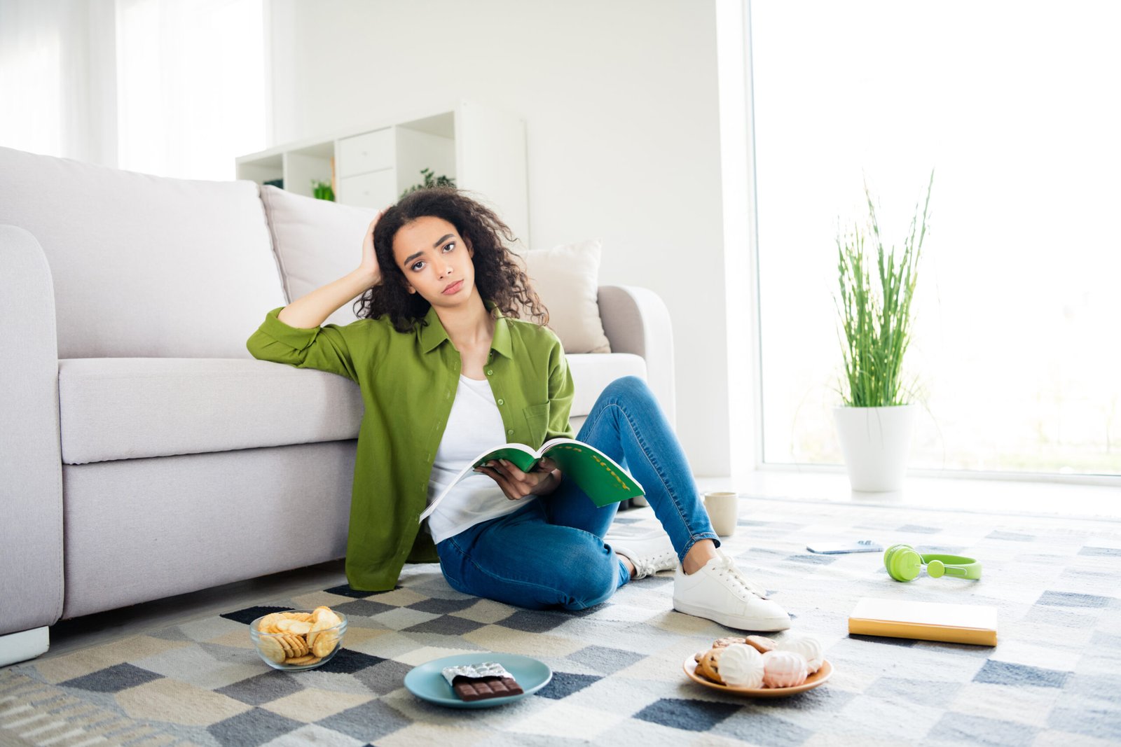 Photo of upset cute charming girl sit floor carpet hold book homework lesson break pause education from home indoors