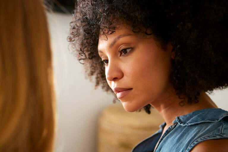 Close Up Shot Of Two Female Friends Having Serious Conversation At Home Together