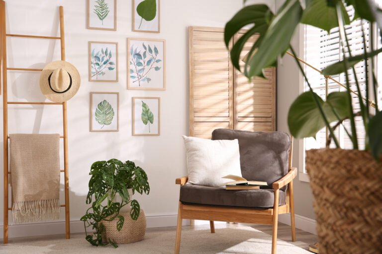 Stylish room interior with different artworks and armchair