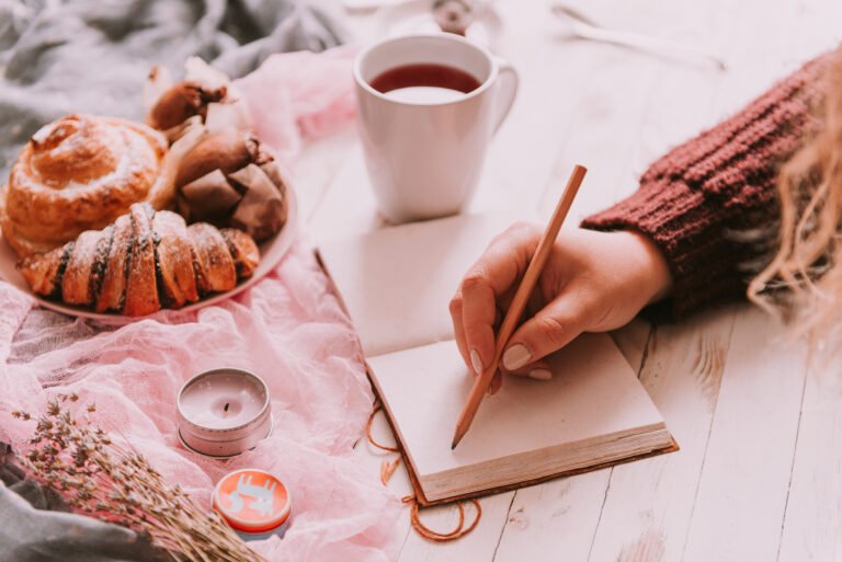 Woman making notes while having breakfast