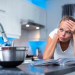 Pretty, young woman  thinking about what to cook for her family