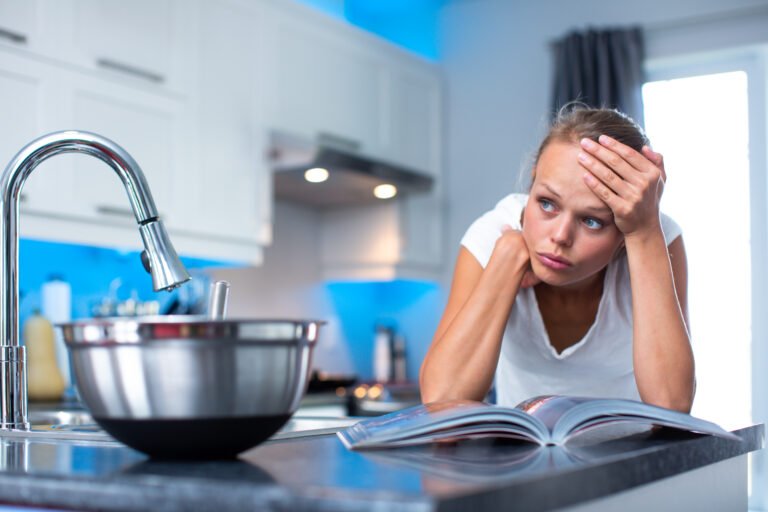 Pretty, young woman  thinking about what to cook for her family